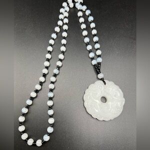 Asian style glass necklace with carved pendant